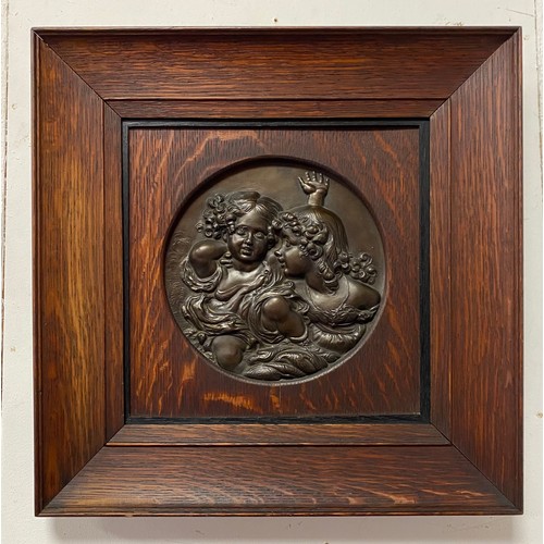 66 - A bronze roundel, depicting two girls, probably French, in oak frame -