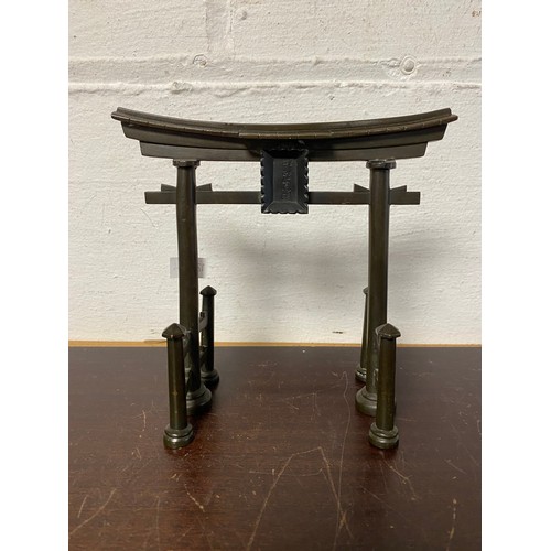 76 - A Japanese bronze model of a Torii gate, signed -