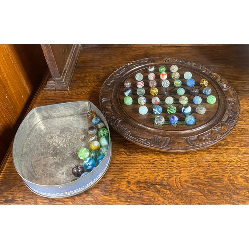 161 - A cased solitaire board, with vintage marbles -