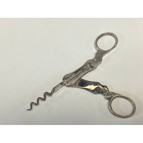 233 - A vintage Perrier Jouet folding combination corkscrew/cutter -