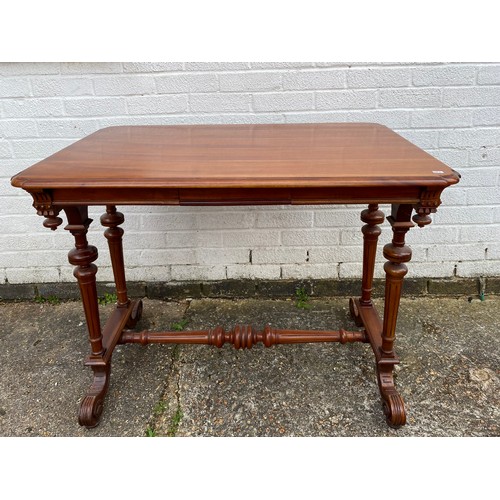 231 - A Gothic style side table, with carved and fluted supports, united by a pole stretcher -