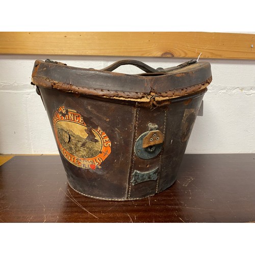 161 - A vintage leather top hat case, with railway labels to exterior and velvet lining -