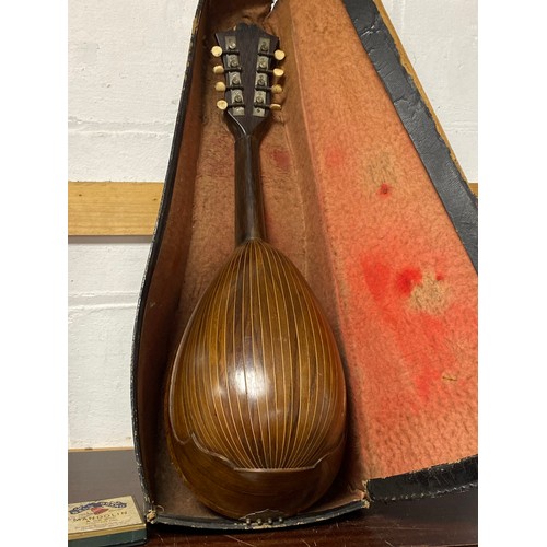 165 - A cased Alfonso Moretti mandolin -