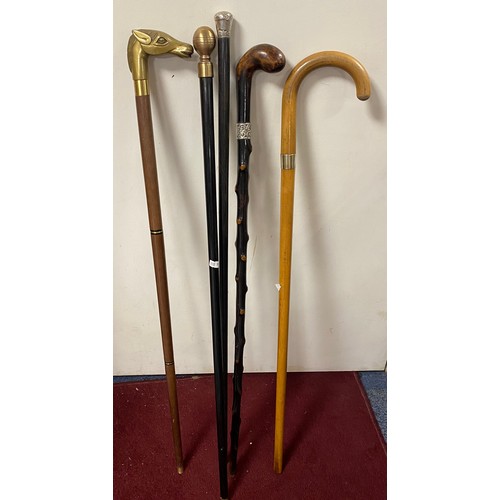 182 - A group of five walking sticks, including three with silver mounts and one with brass horse head and... 