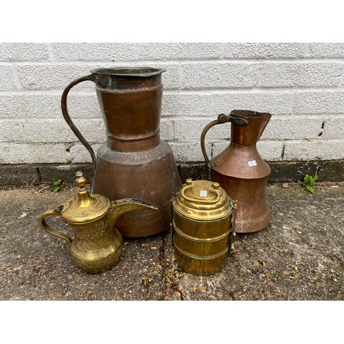 183 - A large Middle Eastern copper ewer, together with a brass coffee pot, tiffin pot and another copper ... 