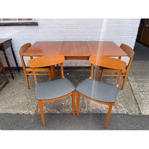 235 - A mid-century teak dining suite, by Beautility, with extending table and four chairs -