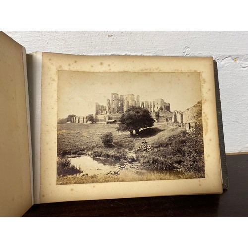 207 - A 19th century photograph album, containing African images, views of Warwick and birds -