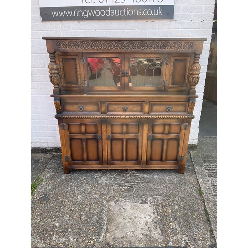 279 - An oak Old Charm style court cupboard, with cabinet/cupboard doors over three drawers and cupboard d... 