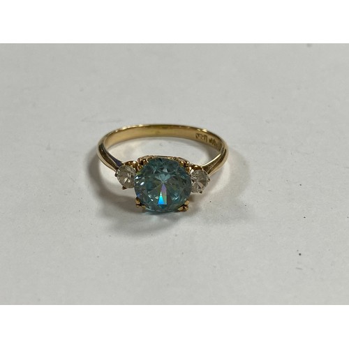 4 - An 18ct gold ring, set with a blue zircon between white stones -