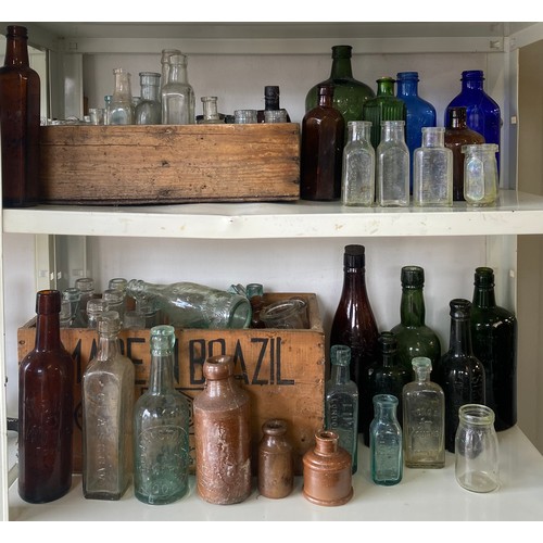 129 - A quantity of antique bottles, many moulded with names -