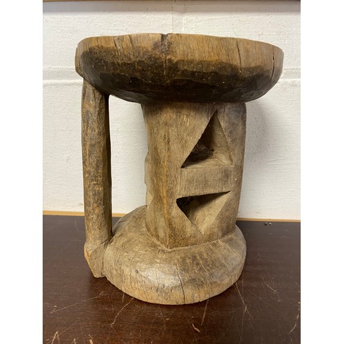 216 - Of Tribal interest: a carved hardwood stool -