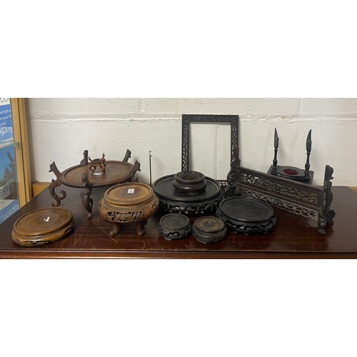 95 - A quantity of Chinese carved hardwood stands -