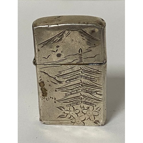 32 - A silver cased lighter, stamped sterling silver, with pagoda and mountain scene -
