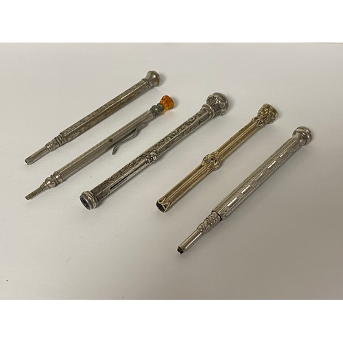 33 - A group of five pencils, including one silver cased example with stone set end -