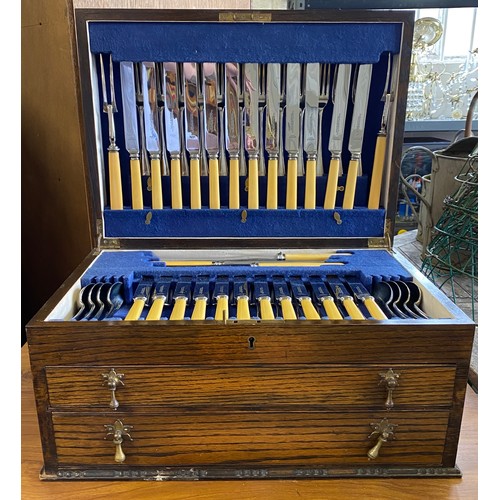 44 - An oak cased canteen of cutlery, for twelve, the canteen fitted with lift top over two drawers -