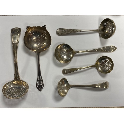 52 - A Georgian silver sifter spoon, together with a silver strainer spoon and four plated sifter spoons ... 
