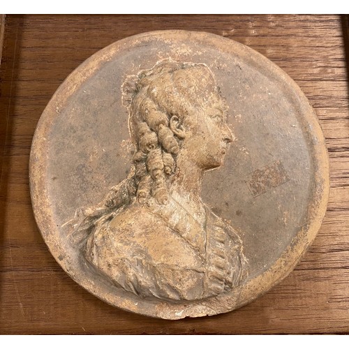 102 - A terracotta roundel, modelled with a female bust -