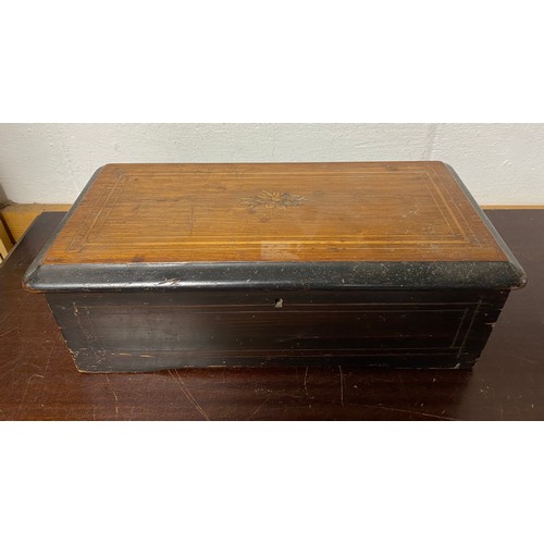103 - A 19th century Swiss music box, the rosewood case with garland inlay, playing 6 airs -