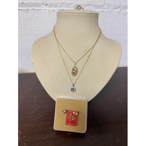 64 - Two 9ct gold gem set pendants on chains, a pair of pearl earstuds and a 9ct gold ring mount -