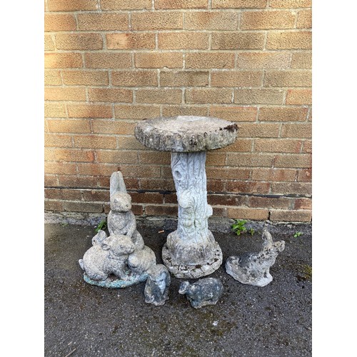 404 - A bird bath, the column designed as a tree trunk, a rabbit garden ornament etc -