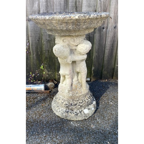 405 - A birdbath, the column designed as cupids -