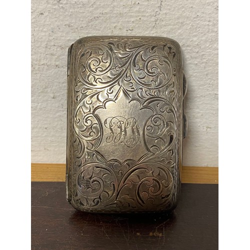 76 - An early 20th century silver cigarette case, Birmingham 1920, with engraved decoration -