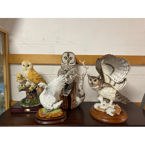 161 - A Franklin Mint Great Grey Owl, together with three other bird models -
