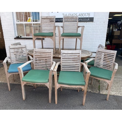 419 - A teak garden table, with eight matching chairs -