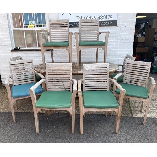 419 - A teak garden table, with eight matching chairs -