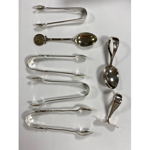 80 - A mixed group of silverwares, various dates and makers, including three pairs of silver tongs, chris... 