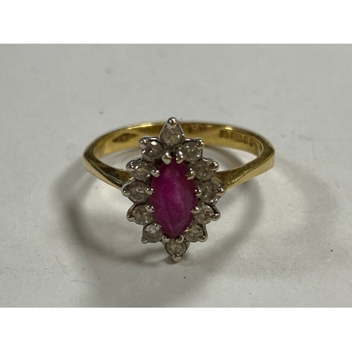 84 - A ruby and diamond ring, set with a marquise cut ring in a border of diamonds, in 18ct gold -