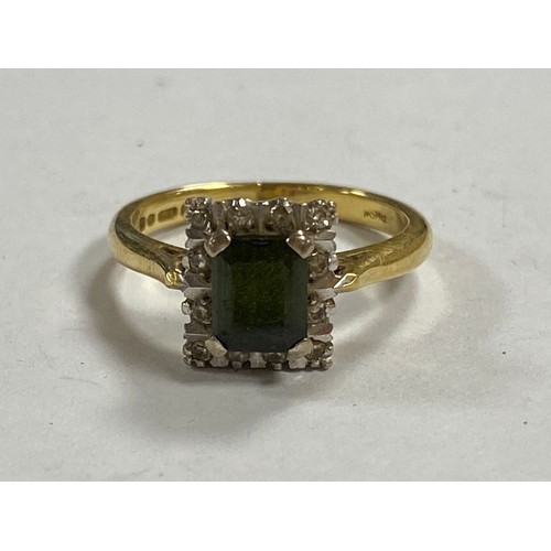 85 - A tourmaline and diamond set dress ring, set with a rectangular green tourmaline within a border of ... 