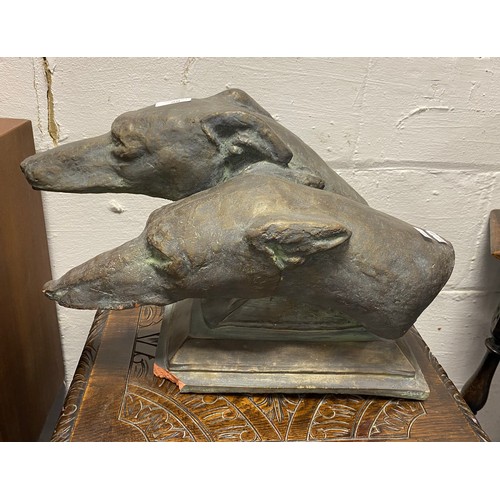 90 - A bronzed terracotta model of two dogs heads -