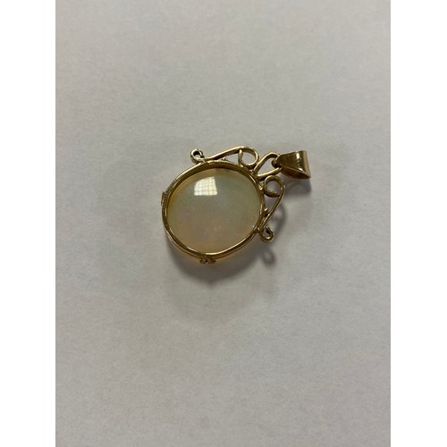 41 - An opal single stone pendant, the oval opal in unmarked yellow gold mount-