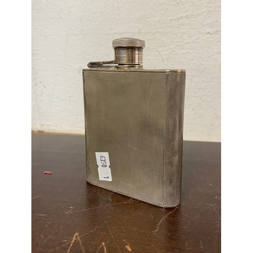 8 - A George VI silver hip flask, Birmingham 1939, with textured body -
