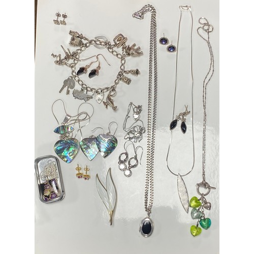 32 - A quantity of mostly silver jewellery, including charm bracelet, bangles, locket and other pendants ... 