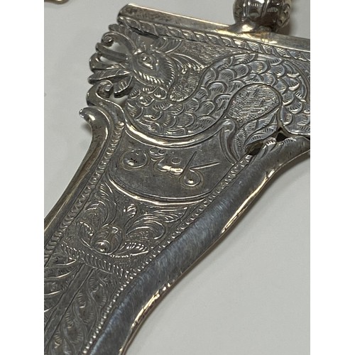 34 - A Malaysian white metal kris dagger, together with another engraved with camel and dhow -