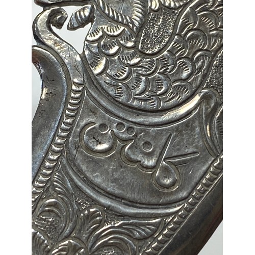 34 - A Malaysian white metal kris dagger, together with another engraved with camel and dhow -