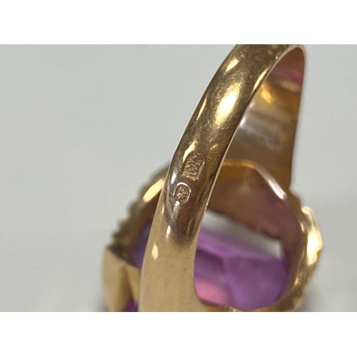 45 - A continental yellow metal ring, set with a purple step cut gemstone, foreign control marks -