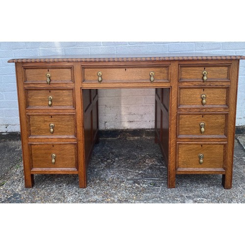 366 - An oak desk, fitted with three frieze drawers over drawers on short legs -