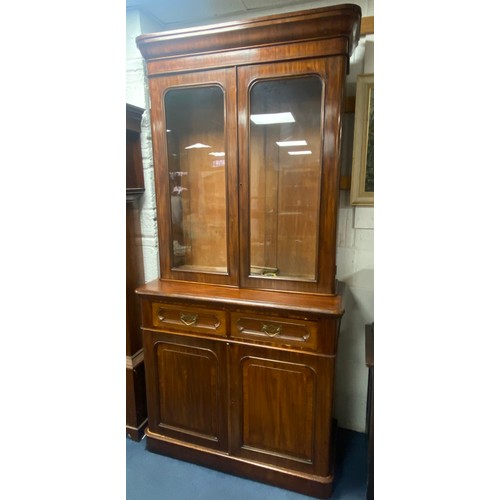 372 - A Victorian mahogany and crossbanded bookcase, with stepped cornice over two drawers and cupboard do... 