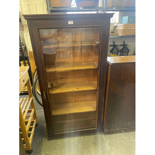 374 - A floorstanding display cabinet, with single glazed door -
