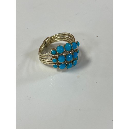 22 - A yellow metal five band 'harem' ring, set with turquoise and clear stones -