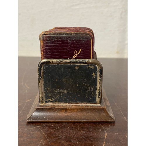47 - An Edwardian silver mounted miniature book rack, London 1904, containing five miniature volumes of C... 