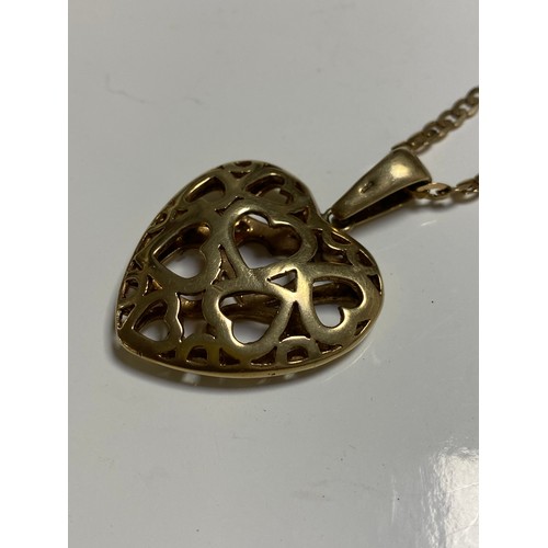 49 - A 9ct gold heart pendant, with pierced decoration on chain -