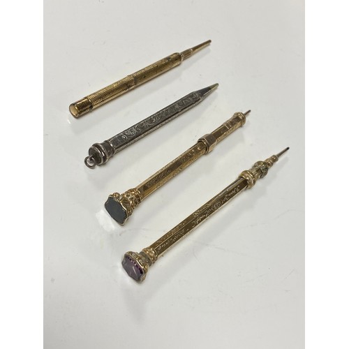 56 - A Victorian propelling pencil, with amethyst seal end, another inset with a bloodstone panel, a silv... 
