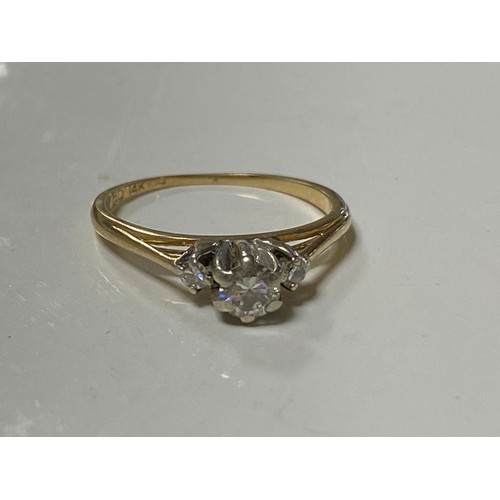 4 - A diamond ring, the central diamond set between smaller diamonds in 14ct gold mount -