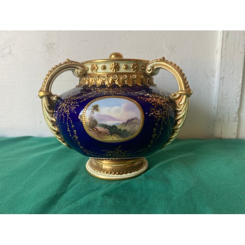 115 - A Coalport three handled pot pourri and cover, painted with three vignettes and lakeside views on a ... 