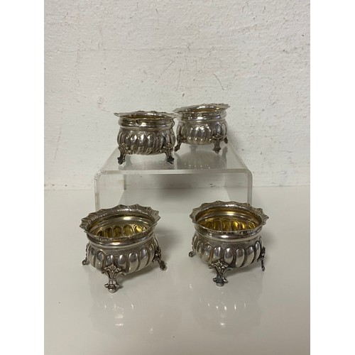 8 - A set of four continental white metal open salts, each raised on four legs -