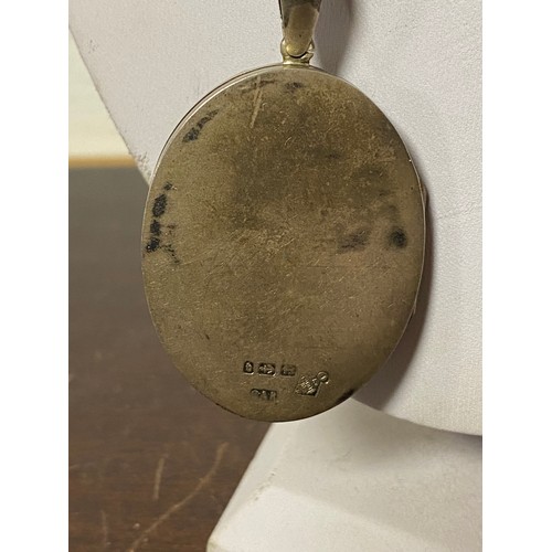 11 - A Victorian silver locket and collar, the cover decorated with a 'Xmas Chimes' bell, holly and a rob... 